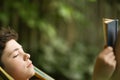 Teenager boy reading in hammock Royalty Free Stock Photo