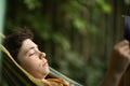 Teenager boy reading in hammock Royalty Free Stock Photo