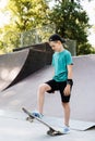 Teenager boy ready for ride on skate board on skateboard park playground. Sports equipment for kids. Extreme lifestyle. Royalty Free Stock Photo