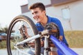 Teenager boy repair tire on bicycle Royalty Free Stock Photo