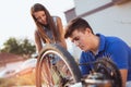 Teenager boy repair tire on bicycle Royalty Free Stock Photo
