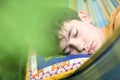 Teenager boy resting sleep with book in hammock on summer green garden Royalty Free Stock Photo