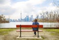 Teenager boy sitting on the Bench in the Toronto Islands, Canada