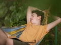 Teenager boy reading in hammock Royalty Free Stock Photo