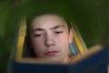 Teenager boy reading in hammock Royalty Free Stock Photo