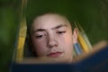 Teenager boy reading in hammock Royalty Free Stock Photo