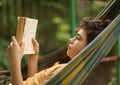 Teenager boy reading in hammock Royalty Free Stock Photo