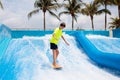 Teenager boy surfing in beach wave simulator Royalty Free Stock Photo