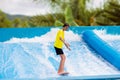 Teenager boy surfing in beach wave simulator Royalty Free Stock Photo