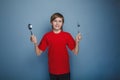 Teenager boy twelve years in a red shirt holding a Royalty Free Stock Photo