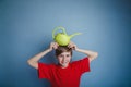 Teenager boy twelve years in red shirt holding a Royalty Free Stock Photo