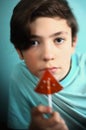 Teenager boy with water melon shape sugar candy on stick Royalty Free Stock Photo