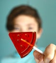 Teenager boy with water melon shape sugar candy on stick Royalty Free Stock Photo