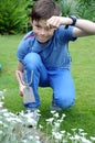 Teenager boy weeding the beds in the garden