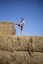 Teenager boy on a wheat stack