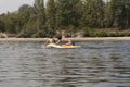 Teenager boys surfing on tropical beach in Europe. Kids on surf board on river wave. Active water sports for kids. Kid swimming