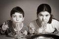 Teenager brother and sister eating Italian dinner spaghetti with sauce funny photo