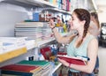 teenager buying different products in stationery shop