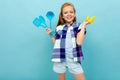 Teenager caucasian girl is going to cook something with kitchenware isolated on blue background