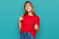 Teenager caucasian girl wearing casual red t shirt pointing fingers to camera with happy and funny face Royalty Free Stock Photo
