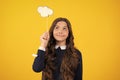 Teenager child girl holding thinking bubble, comment cloud over yellow background. Royalty Free Stock Photo