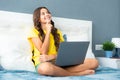 Teenager child girl working on laptop pc computer lying in bed resting relaxing in bedroom at home. teen girl. Happy Royalty Free Stock Photo