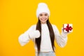 Teenager child hold gift. Funny kid girl in winter hat holding gift boxes celebrating happy New Year or Christmas Royalty Free Stock Photo