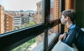 Teenager in coronavirus lockdown looking through the window Royalty Free Stock Photo