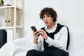 teenager on the couch with the phone internet living room Royalty Free Stock Photo