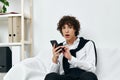 teenager on the couch with the phone internet living room Royalty Free Stock Photo