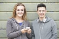 Teenager Couple Sharing Text Message On Mobile Phone Royalty Free Stock Photo