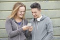 Teenager Couple Sharing Text Message On Mobile Phone Royalty Free Stock Photo