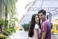 Teenager couple spending time together at theme park on summer weekend, young beautiful lover hanging out and having fun at an