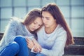 Teenager cries, her girlfriend sympathizes