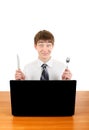 Teenager with Cutlery behind Laptop Royalty Free Stock Photo