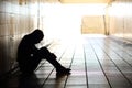 Teenager depressed sitting inside a dirty tunnel Royalty Free Stock Photo