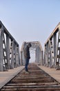 Teenager in depression sitting on the bridge at the sunset. Royalty Free Stock Photo