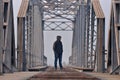 Teenager in depression sitting on the bridge at the sunset. Royalty Free Stock Photo