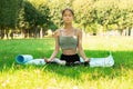 Teenager does yoga in park, sports and fitness outdoor,young woman in nature does exercises, trains Royalty Free Stock Photo