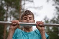 Teenager doing exercise on a horizontal bar