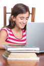 Teenager doing homework on her laptop isolated on white Royalty Free Stock Photo