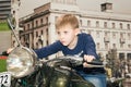 A teenager driving a motorcycle