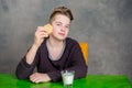 Teenager eating cookie and drink milk