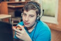 Teenager eating pizza sitting at a laptop. Royalty Free Stock Photo