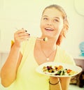 Teenager eating salad Royalty Free Stock Photo