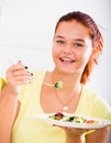 Teenager eating salad Royalty Free Stock Photo