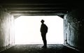 Teenager at the end of a dark tunnel Royalty Free Stock Photo