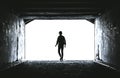 Teenager at the end of a dark tunnel Royalty Free Stock Photo