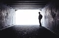 Teenager at the end of a dark tunnel Royalty Free Stock Photo