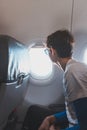 Teenager enjoys travelling on a low-cost plane, fulfilling his adventurous dreams and living his life